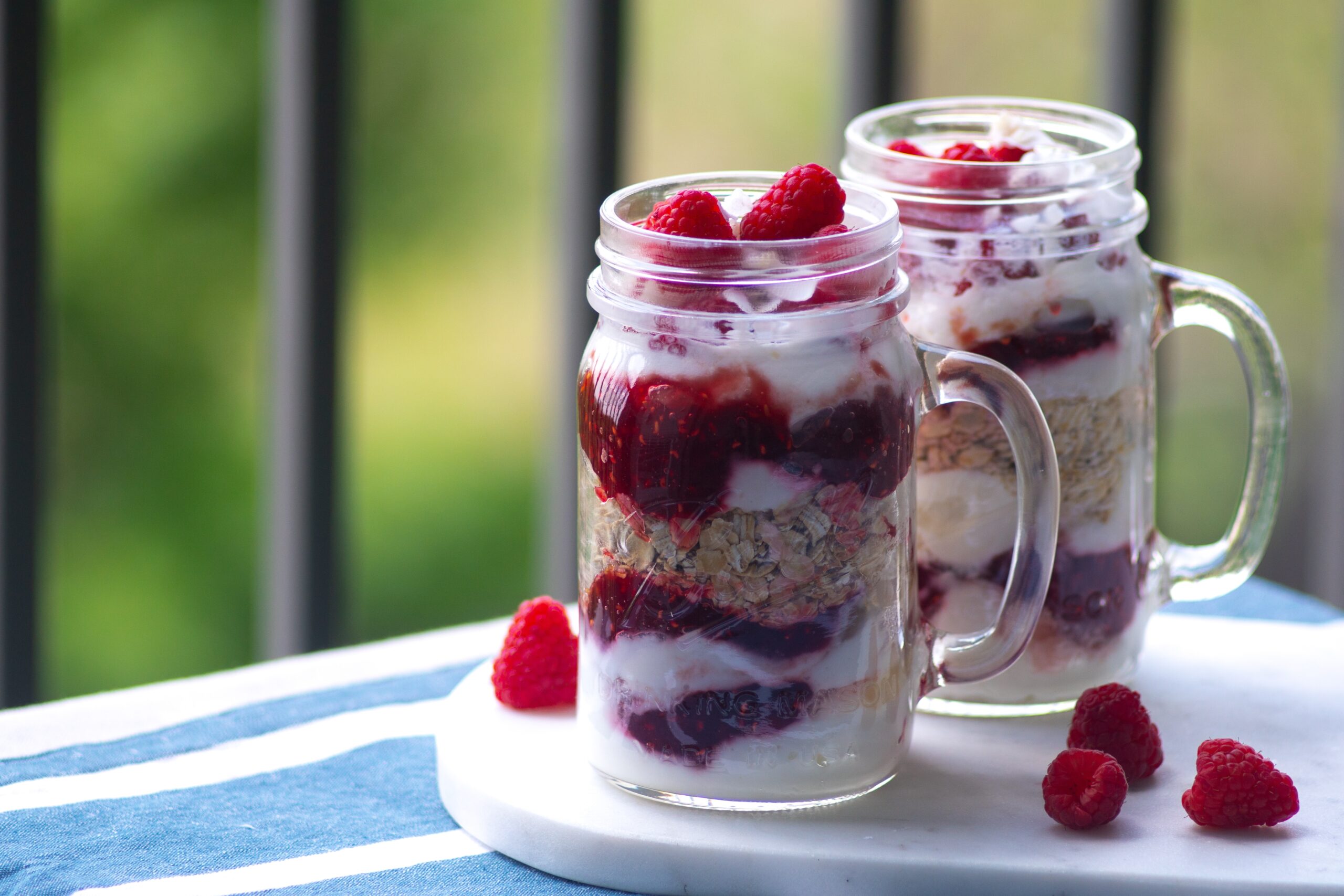 overnight oats in a jar with yogurt and raspberries